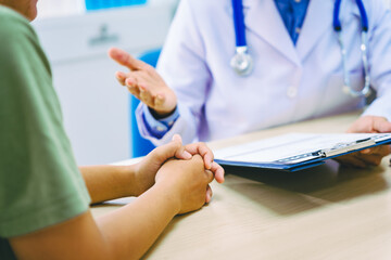 A female patient meets a male doctor at a desk in a hospital, discussing her migraine headache, stress, and insomnia. The doctor provides advice, diagnosis, and treatment options