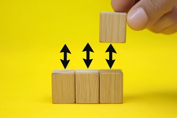Poster - Hand placing wooden block on upward arrows, growth concept.