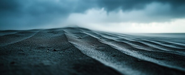 Poster - Dark, wavy sand with foggy horizon under moody sky.