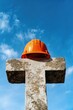 © Alexandr - Construction site cross with hard hat