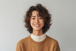 © Surachetsh - A confident young Asian man stands against a light, minimal background in simple, urban clothing, blending casual style with a professional edge.