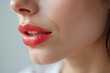 © Andri - Close-up of a woman's lips adorned with vibrant red lipstick, showcasing a glossy and alluring appearance generative ai