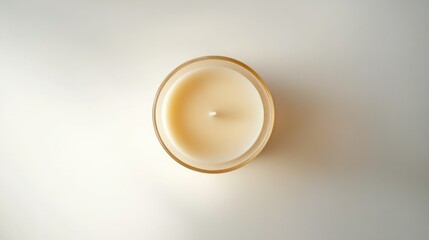Poster - A top view of a creamy white candle in a glass container on a light background.