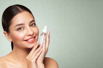 Wall Mural - beautiful elegant woman holding a cosmetic jar of oil serum or hyaluronic acid in her hand. perfect 