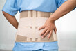 © amazing studio - Asian lady patient wearing back pain support belt for orthopedic lumbar with walker.