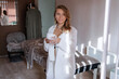 © MarijaBazarova - Attractive blonde woman in white clothes have coffee break in her massage salon