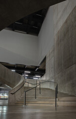 Wall Mural - A curving flight concrete spiral staircase at Blavatnik Building of Tate Modern Switch House extension. Interior main curved stair at Tate modern its distinctive perforated, lattice brickwork and dyna