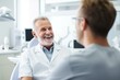 © nsit0108 - Friendly doctor having conversation with patient during consultation in modern clinic