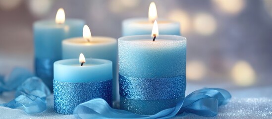 Poster - Blue candles with ribbons glowing softly in a serene ambiance perfect for relaxation and decor in a tranquil setting