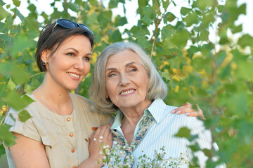 Canvas Print - An elderly woman with her daughter in the park in summer