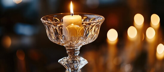 Poster - Elegant glass candlestick with lit candle creating a romantic ambiance in a beautifully decorated wedding reception setting.