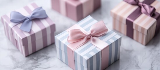 Wall Mural - Colorful striped and plain gift boxes with ribbons on a marble surface ideal for holiday or celebration themed marketing and advertising purposes