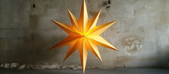 Canvas Print - Elegant paper star decoration for Christmas with vibrant yellow tones against a textured wall backdrop.