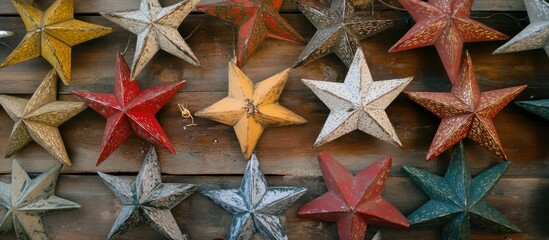 Poster - Colorful Christmas stars in various shapes arranged against a rustic wooden background creating a festive and decorative ambiance.