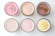 © Oksana - Protein shakes of different flavors in glasses top view isolated on white