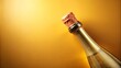 © Ole Studio - Golden Celebration Sparkling Wine Bottle with Cork on Yellow Background