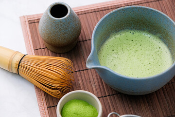 Wall Mural - Traditional matcha kit, Bamboo whisk and beverage on bamboo mat in the kitchen