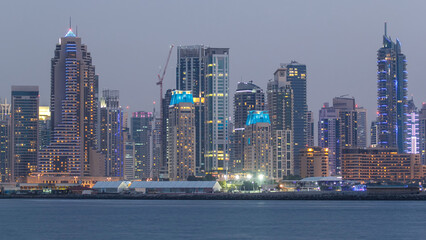 Wall Mural - Dubai Marina skyline day to night timelapse as seen from Palm Jumeirah in Dubai, UAE.