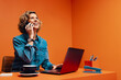 © Jacob Lund - Smiling businesswoman in conceptual orange workspace