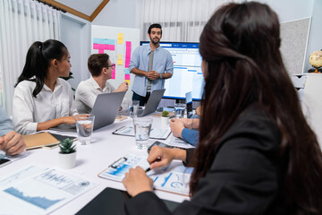 Leinwandbilder - Project manager communicate and collaborate with team using project management software display on monitor, tracking progress of project task and making schedule plan at meeting table. Prudent