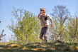 © Linas T - A mischievous and active child running down a forest hill. Photo concept of releasing energy