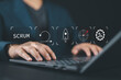 © Nirusmee - SCRUM, agile development methodology concept. Businessman using laptop with SCRUM icons on virtual screen