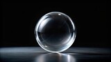 Silhouette of a transparent glass sphere against a black background