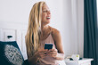 © BullRun - Happy Caucasian woman with cellphone technology in hands recreating in home interior during weekend time, cheerful influence blogger 30s connected to wifi internet on modern smartphone gadget