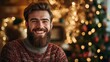 © kachanovski - A bearded man in a warm sweater, smiling in a cozy, festive environment with a Christmas tree in the background