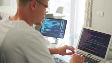 Game developer streams code, showing changes during video call.