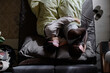 © AnnaStills - top down shot of sleepy woman cuddling her husband while sleeping together in bed