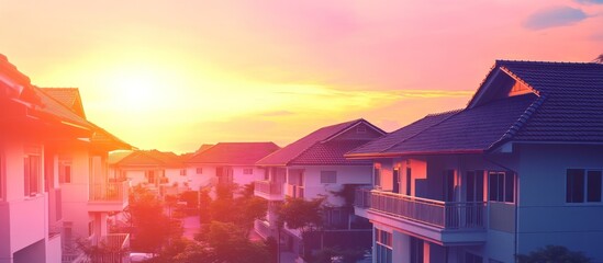 Sticker - A serene sunset over residential houses, creating a warm and inviting atmosphere.