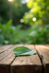 Aufkleber - A real wood table features a blurred leaf on a textured wooden surface surrounded by a natural outdoor garden setting._00001_