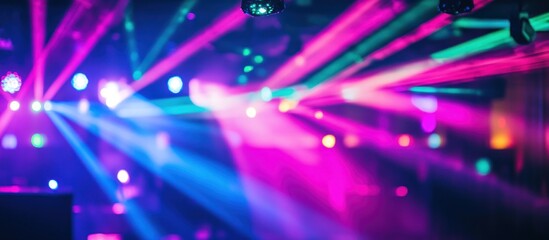 Wall Mural - Colorful laser lights illuminate a vibrant nightclub scene.