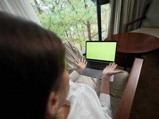 Canvas Print - Woman expressing surprise while using a laptop in a serene, nature inspired setting, showcasing emotions and technology