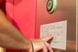 © ADDICTIVE STOCK - Close-up of hands reading Braille beside a button panel