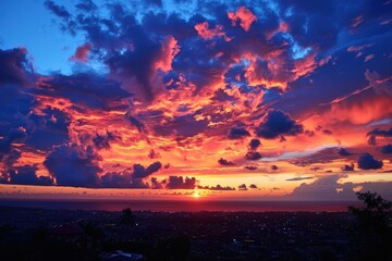 Poster - Vivid sunset over the ocean with dramatic clouds reflecting a spectrum of colors at twilight