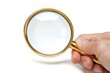 © Nico - Hand Holding a Magnifying Glass for Searching