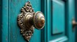 © Kristina - Intricately designed vintage brass door knob mounted on a vibrant teal wooden door, showcasing elegant decor and emphasizing classical architectural style
