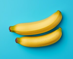 Canvas Print - Two ripe yellow bananas on a blue background.