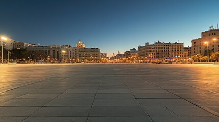 Poster - A serene urban square at dusk, illuminated by streetlights and surrounded by buildings.