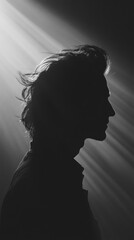 Aufkleber - A silhouette of a person against dramatic lighting, creating a moody atmosphere.