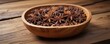© Wachiraporn - Wooden bowl filled with star anise on a rustic wooden table, spice, nature-inspired