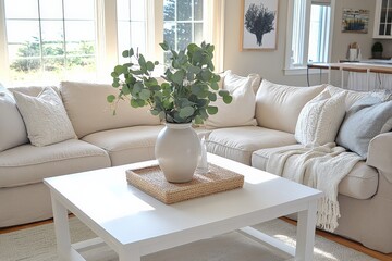 Poster - A bright lounge area showcases a beige sectional sofa, beautifully arranged around a white coffee table with a centerpiece of eucalyptus, inviting relaxation and warmth.