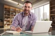 © BillionPhotos.com - Happy handsome entrepreneur man work on laptop at office