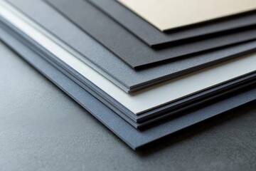 Poster - This close-up image showcases a beautifully arranged stack of textured papers in different shades, highlighting the smooth edges and intricate details of each layer.