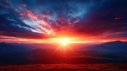 Poster - A beautiful sunset over a grassy hillside with mountains in the background