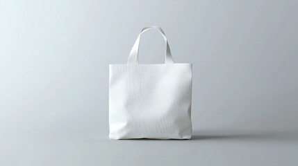 Fototapete - White tote bag displayed on a plain grey background, design mockup for branding concepts