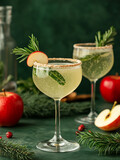 Drink w wysokim kieliszku i jabłka w tle