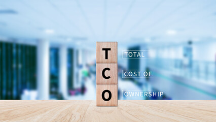 Fototapete - TCO concept. Total Cost of Ownership text on a wooden block, purchase price of an asset plus the costs of operation, business concept background